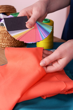 Samples of colorful fabric in female hands, closeup