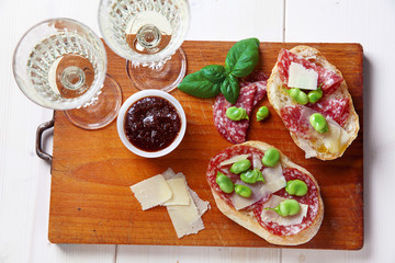 Italian snacks. salami sandwich with parmesan cheese & broad bea