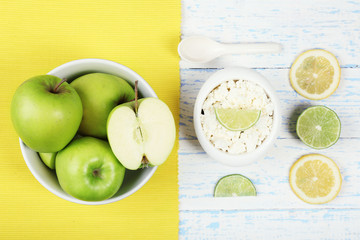 Apples, cottage cheese and lemons on wooden table top view