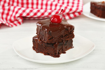 Delicious chocolate cakes on plate on table close-up
