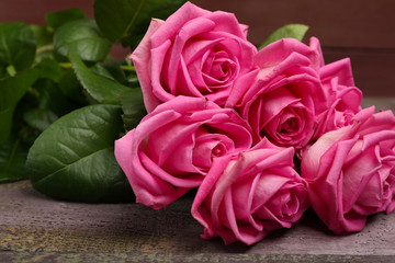 Beautiful pink roses on table close up
