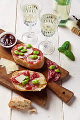 Italian snacks. salami sandwich with parmesan cheese & broad bea