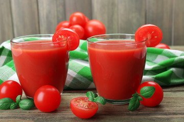 Glasses of tomato juice with vegetables on table close up