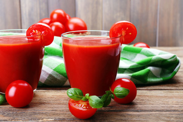 Glasses of tomato juice with vegetables on table close up
