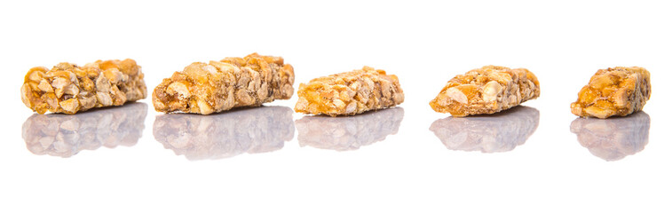 Caramelized candy nuts over white background 