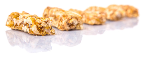 Caramelized candy nuts over white background 