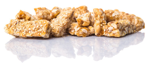 Caramelized candy nuts over white background 