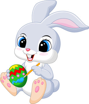 Cute Easter Bunny painting an egg