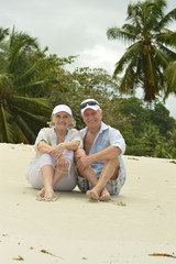 Elderly couple sitting on a bench outdoors