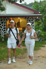Obraz premium Elderly couple with backpacks in the journey