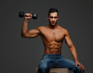 Fototapeta na wymiar Shirtless muscular man holding dumbell