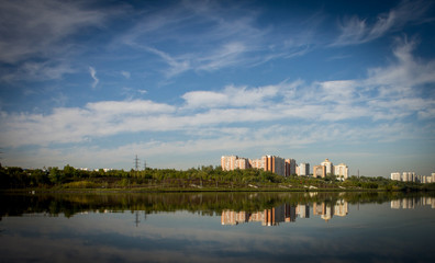 Fototapeta na wymiar multi-storey buildings are reflected in the river