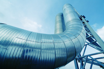 Industrial zone, Steel pipelines and valves against blue sky