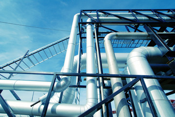 Industrial zone, Steel pipelines and valves against blue sky