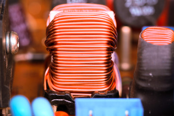 Small winding coils and capacitors are mounted on a baseplate.