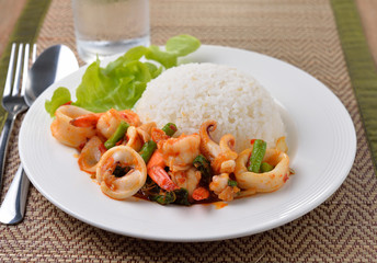 stir fried squid with chilli and basil on white plate