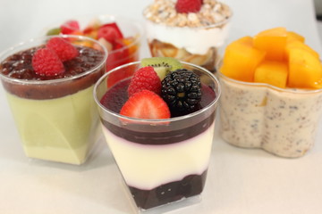  Different colorful dessert in small glass.