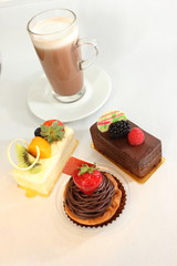  different fruit  decorated pastries  cakes and slices of cakes.