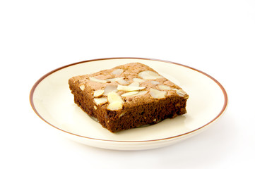 Fototapeta na wymiar chocolate cake with almonds on white isolated background