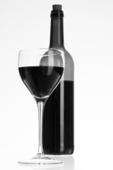 Wine glass and bottle with red wine