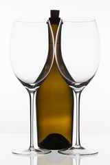 Two empty glasses of wine and brown bottle