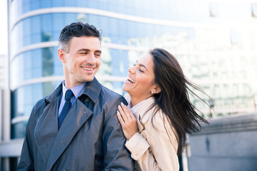 Laughing couple flirting outdoors