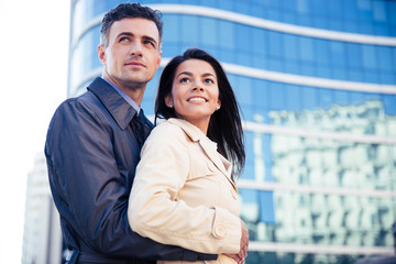 Smiling young couple hugging outdoors