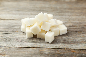 Sugar cube on grey wooden background