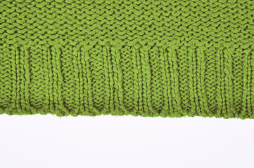 Green knitted sweater close up, isolated on white