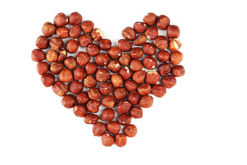 Heart from hazelnuts isolated on white