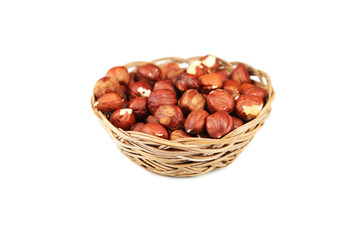 Hazelnuts in basket isolated on white