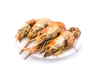 Grilled shrimps on the white plate in white background.