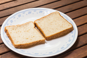 Two slices of plain wholemeal bread on plate