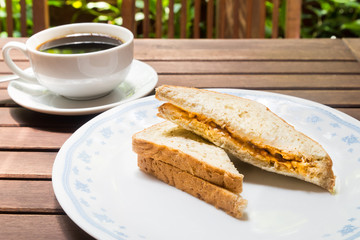 Wholemeal sandwich bread with black coffee at the background 