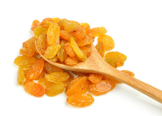 Dried raisins in the wood spoon on a white background