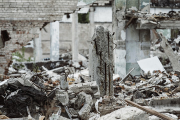 A closeup image of a ruined building with concrete and armature