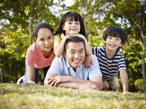 happy asian family in nature