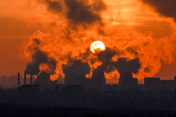 Sunset through the smoke and steam cogeneration station 