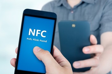 Hand holding smartphone with NFC technology