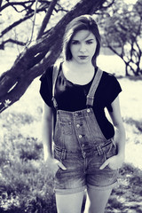 Beautiful young woman in dungarees - obrazy, fototapety, plakaty