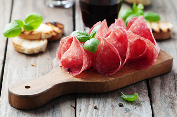 Delicious salami with basil and wine - obrazy, fototapety, plakaty