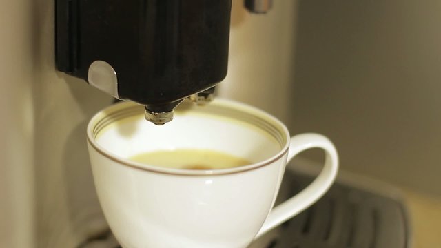 Making coffee. Coffee machine. Hot coffee.