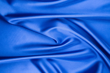 Soft folds of blue silk cloth.