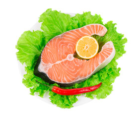 Fresh salmon steak on lettuce.