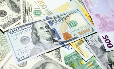 Background of euro and dollar bills. Shallow focus.