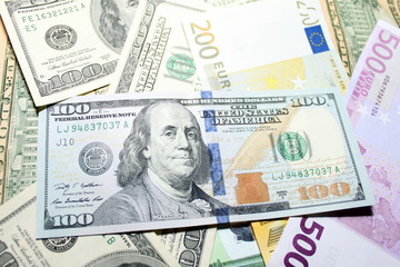 Obraz na płótnie Canvas Background of euro and dollar bills. Shallow focus.