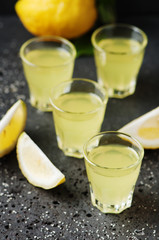 Italian traditional liqueur limoncello with lemon