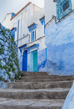 Street with blue and white buildings in Chefchaouen, Morocco.