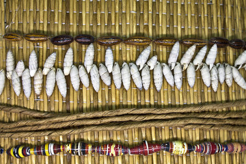 straw mat background with shells and beads