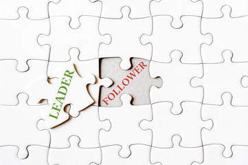 Fototapeta premium Missing jigsaw puzzle piece with word LEADER